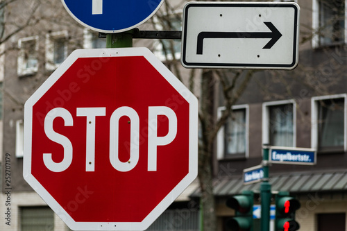 Closeup shot of stopsign and direction sign in Essen, Germany