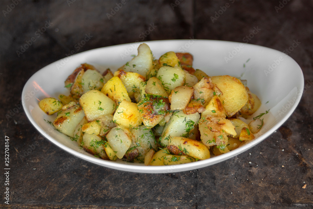 Fresh potatoes with butter and dill baked in a furnace.
