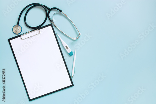 Blue medical background with clipboard and stethoscope