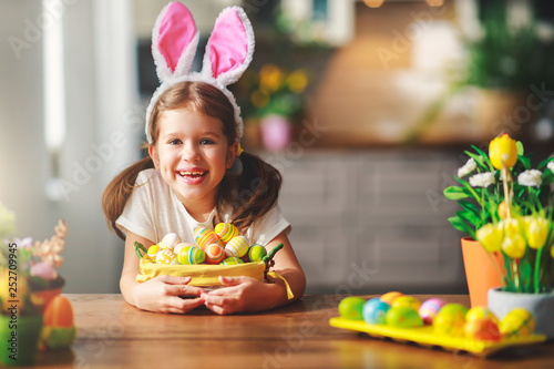 Happy easter! funny child girl with rabbit ears and  eggs