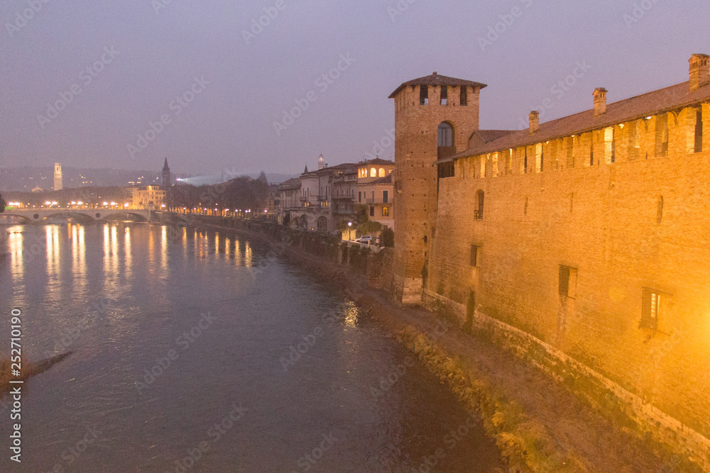 Adige River and ancient wall of Castelvecchio at night, Verona, Italy.