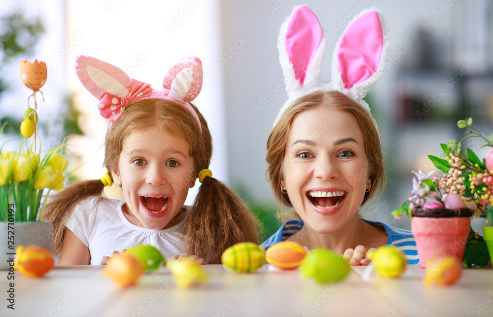 Happy easter! family mother and child daughter with ears hare getting ready for holiday Happy easter! family mother and child daughter with ears hare getting ready for holiday
