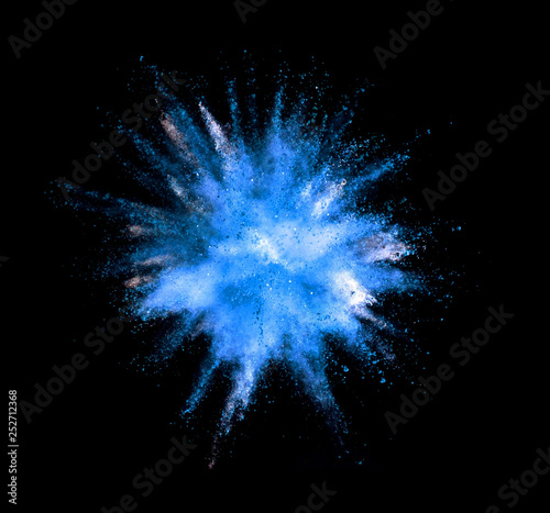 Explosion of blue powder on black background