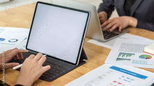 businesswomen are going to save data on a laptop, On the desk with annual summary graph.