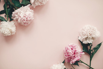Happy mother's day. International womens day. Greeting card mockup. Stylish pink and white peonies  border on pink paper flat lay with space for text.