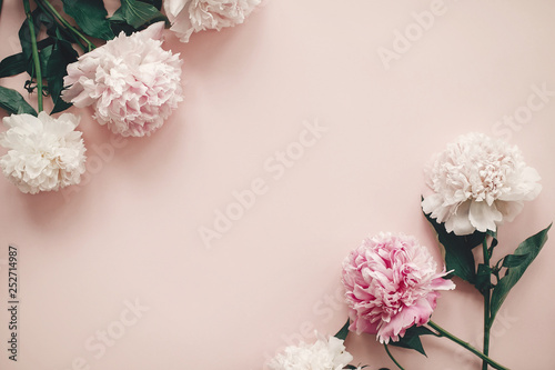 Happy mother's day. International womens day. Greeting card mockup. Stylish pink and white peonies border on pink paper flat lay with space for text.