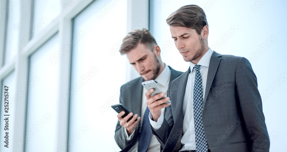 business colleagues sitting in the hallway of the office business colleagues sitting in the hallway of the office