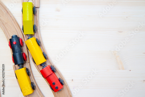 Top view on multicolor kids toy train cars bricks on wooden railway blue background. Copyspase. flat lay. Children toys on the table