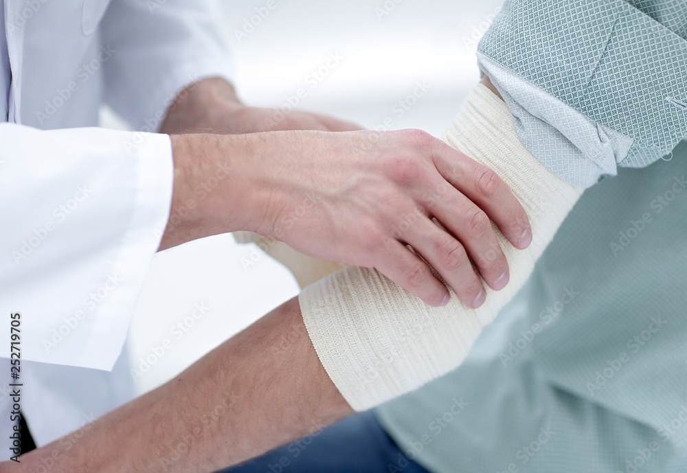 closeup.doctor applying elastic bandage closeup.doctor applying elastic bandage