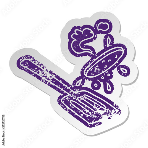 distressed old sticker of a burger being flipped