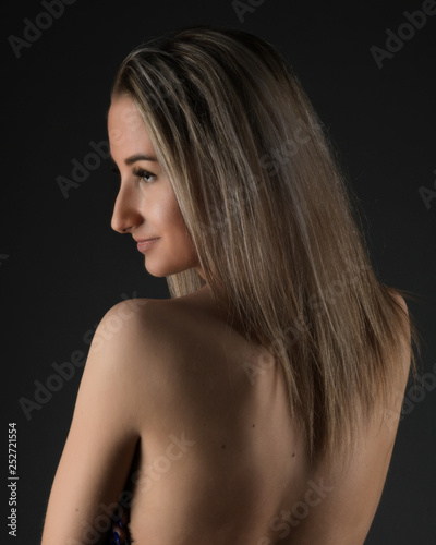 beautiful woman with long blond hair on black background 