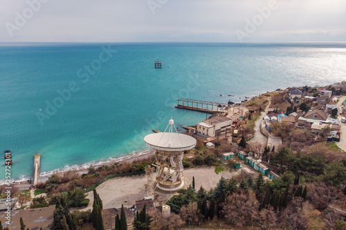 Radio telescope RT-22 in Simeiz Observatory, Crimea. Big white satellite dish antenna on sea coast for astronomy research photo