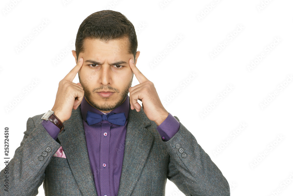 Deeply concentrating. Studio shot of a handsome dark haired man in a suit concentrating trying to find his focus Deeply concentrating. Studio shot of a handsome dark haired man in a suit concentrating trying to find his focus