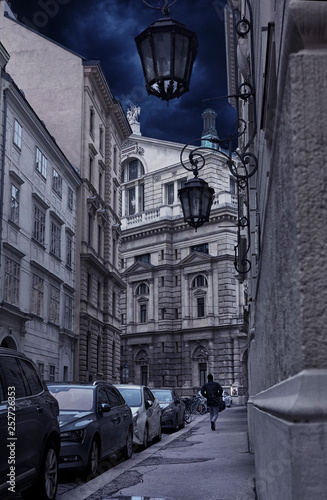 Canvas Print Old stree with architecture behnind The Burgtheater at the Ringstrasse in Vienna in back side view - Austria