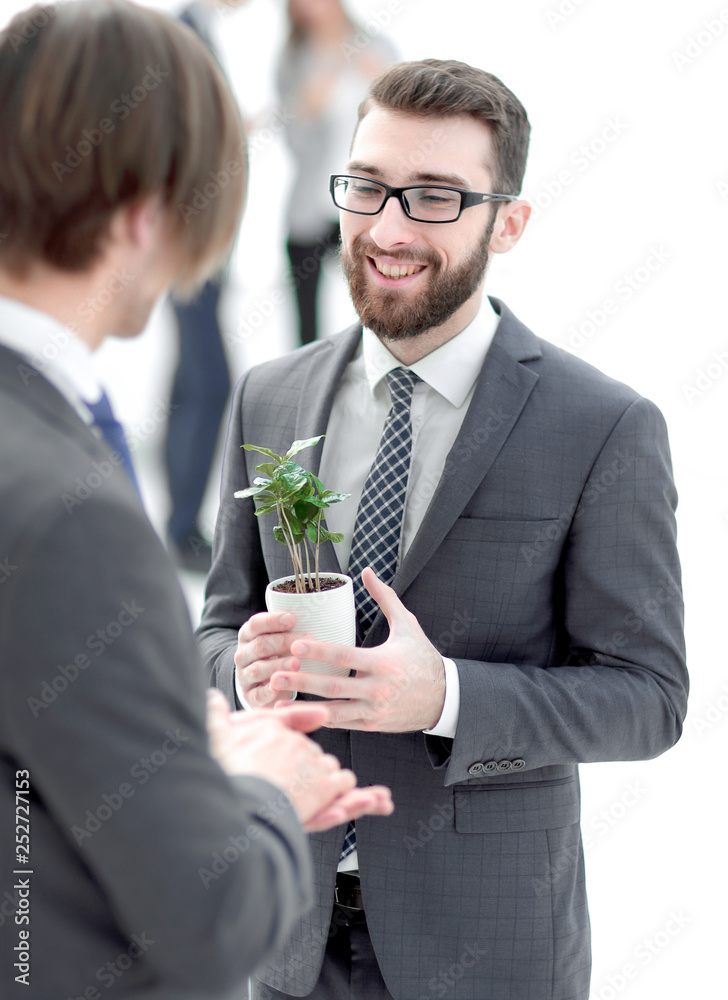 successful young businessman with young sprout successful young businessman with young sprout
