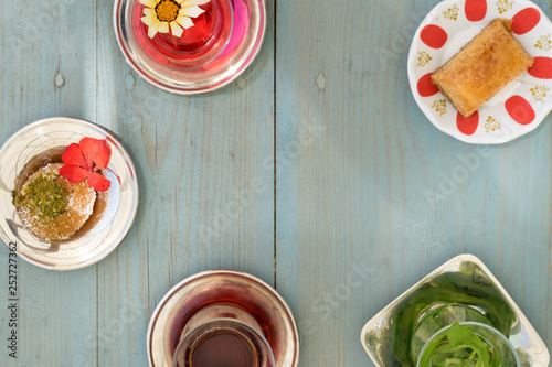 Obraz na płótnie traditional Turkish red black tea tulip glass green flowers sweet dessert afternoon tea break w salonie