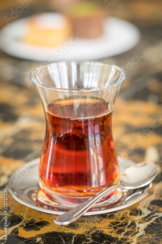 Obraz na płótnie traditional Turkish red black tea tulip glass green flowers sweet dessert afternoon tea break w salonie