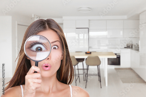 фотографія Home shopping funny inspection woman searching through magnifying glass at kitchen furniture
