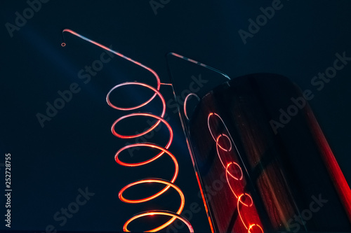 Vat and metallic spiral of alcohol machine red illuminated photo