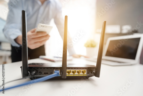 Obraz na płótnie Wireless router concept. Man using smartphone