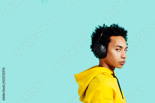 Portrait of young man listening to music with headphones