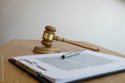 Close up object  law concept. Judge gavel with justice lawyers and documents working on table.