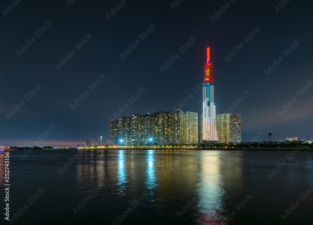 Ho Chi Minh City, Vietnam - February 4th, 2019: Colorful night scene from Landmark 81 riverside with many sparkling lights welcome lunar new year. Landmark 81 is the tallest building in Vietnam