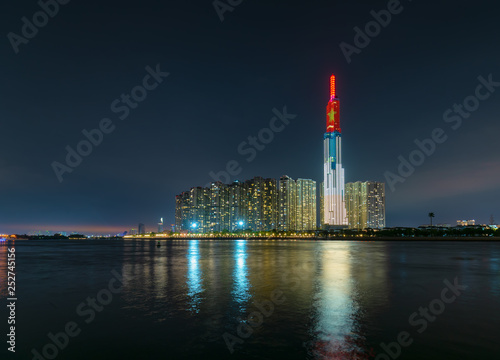 Ho Chi Minh City, Vietnam - February 4th, 2019: Colorful night scene from Landmark 81 riverside with many sparkling lights welcome lunar new year. Landmark 81 is the tallest building in Vietnam photo