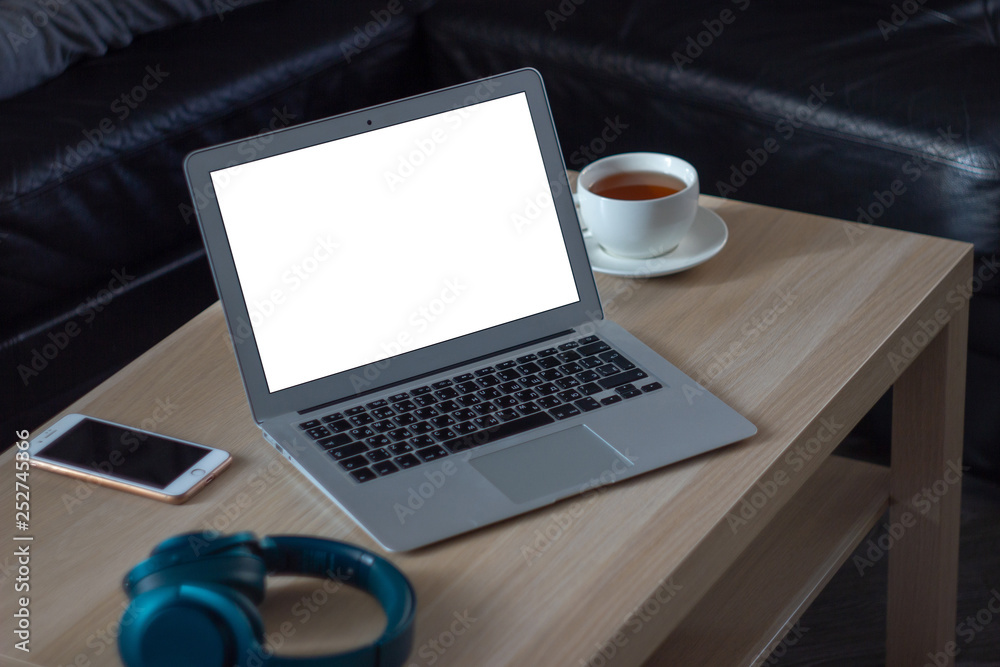 Workplace of a man with laptop and a cup of tea Workplace of a man with laptop and a cup of tea