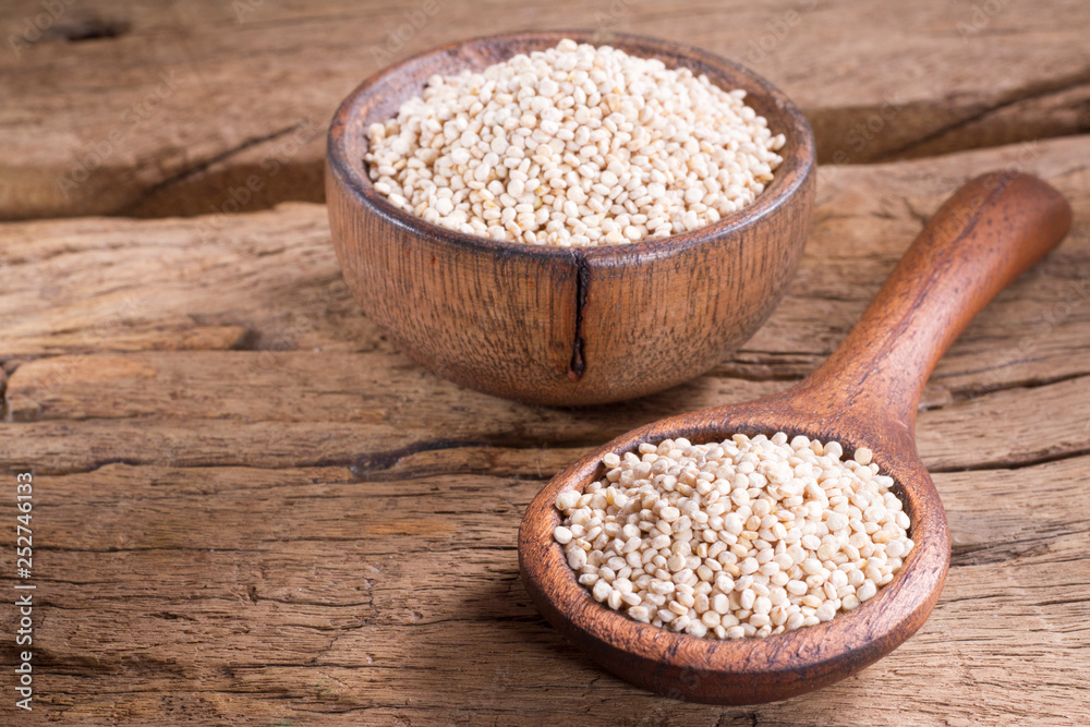 Quinoa seeds in bowl on rustic wood Quinoa seeds in bowl on rustic wood
