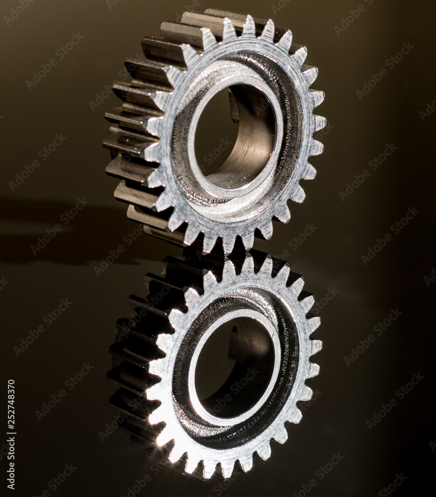 transmission parts from a race motorcycle engine on a reflective background transmission parts from a race motorcycle engine on a reflective background