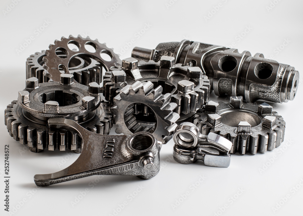 transmission parts from a race motorcycle engine on a reflective