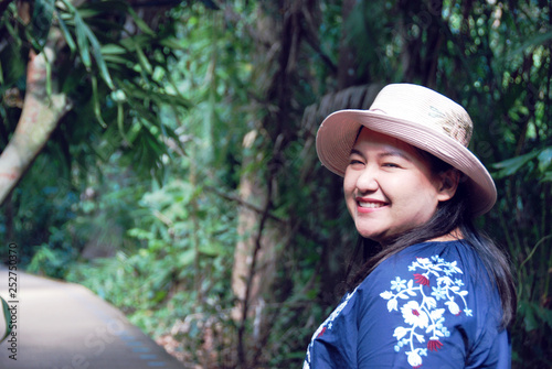 Beautiful woman smile and traveling in the forest