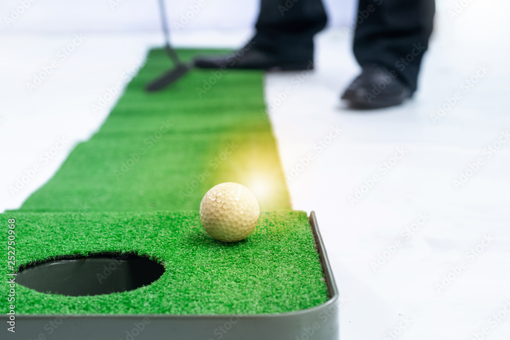 Cropped image of business executive playing mini golf in office, white  background Stock Photo | Adobe Stock