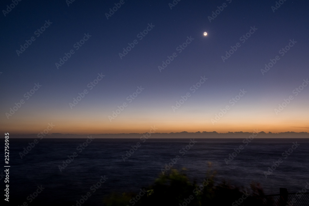 moon and dawn horizon at the beach