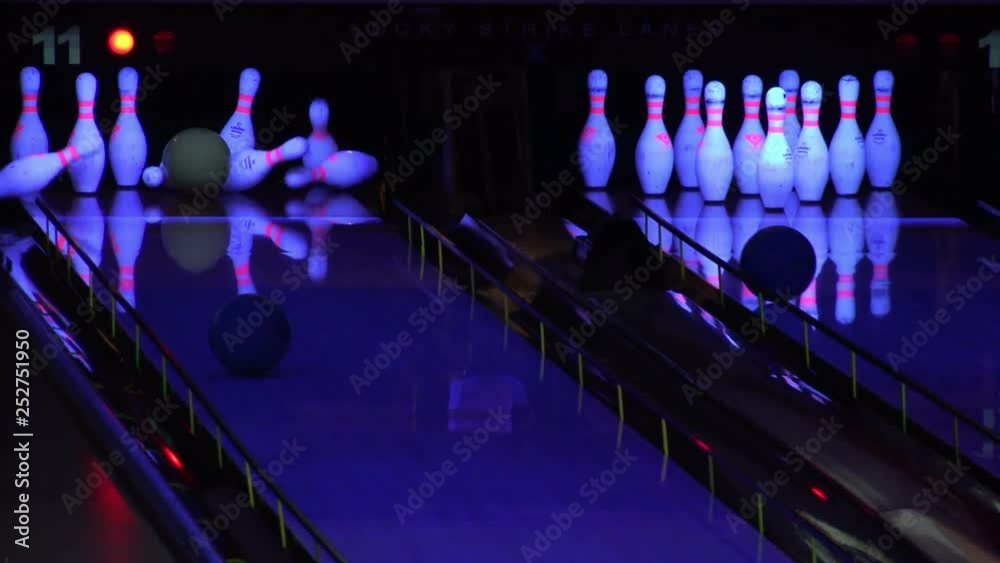 Bowling ball knocking down pins in a bowling alley Stock Video Adobe