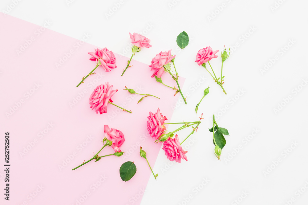 Pink and white background with pink flowers. Flat lay. Top view