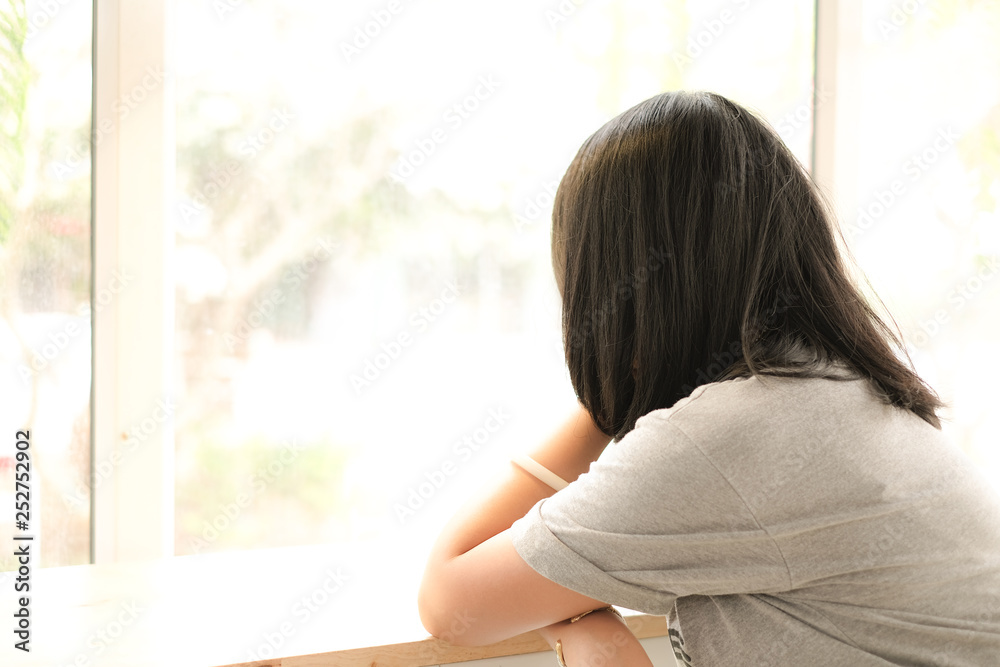 Depressed women, Asian beautiful girl at the window.