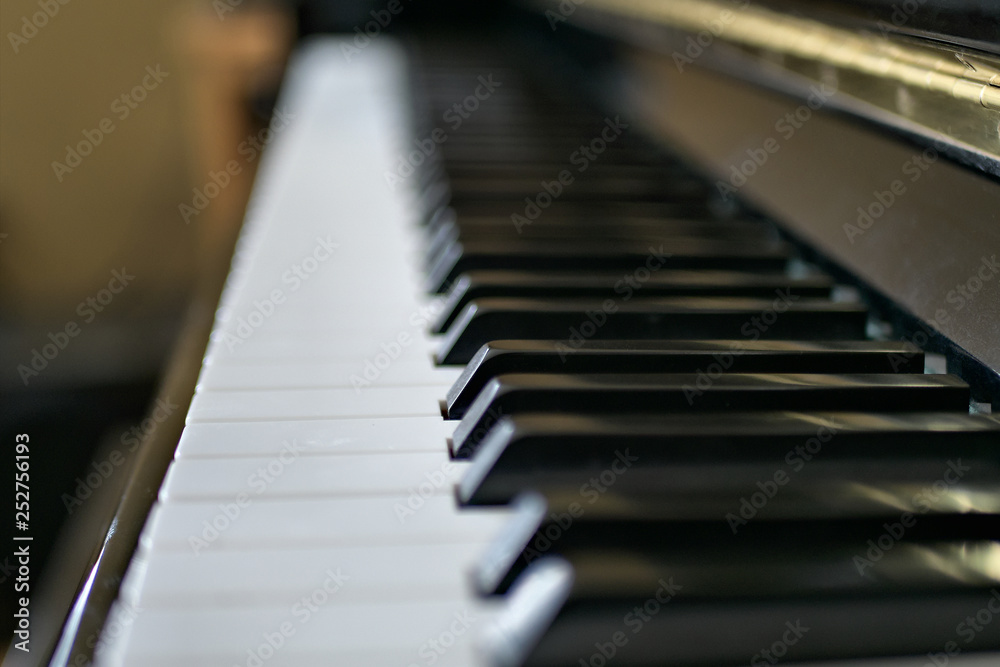 Piano keys close up with black and white keyboard and shallow depth of field.