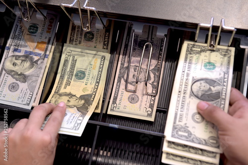 High angle view of cashier searching for change in cash