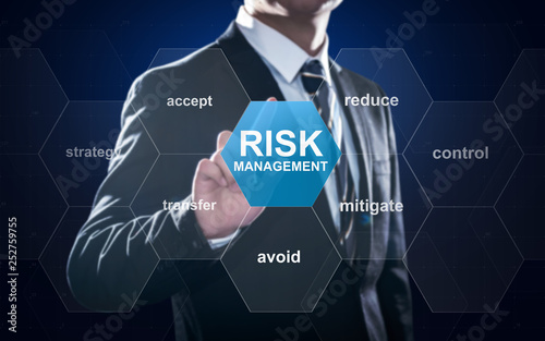 Businessman pointing at risk management concept on screen photo
