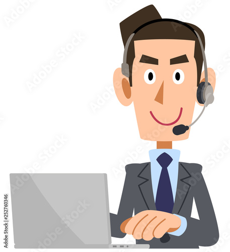 パソコンを操作するヘッドセットを装着したスーツの男性