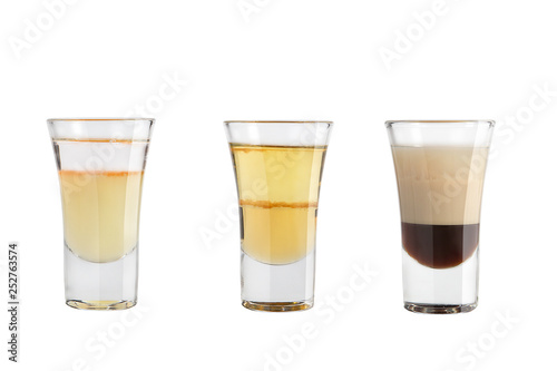 Set of alcohol shots on a white background. Three shots of a variety of alcoholic.