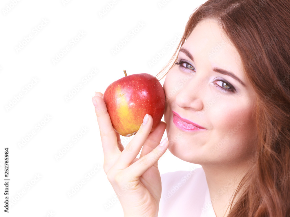 Woman holding apple fruit close to face Woman holding apple fruit close to face