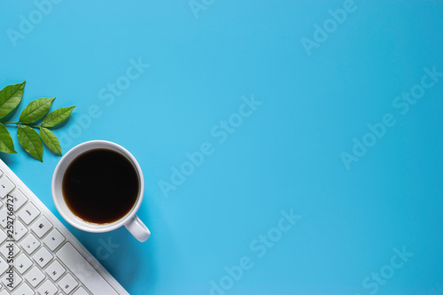 Top view keyboard notebook pen  or object for office supply concept on blue background.