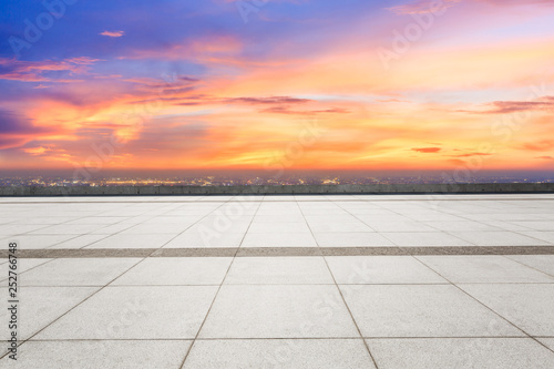 Empty square floor and modern city skyline with beautiful colorful clouds at sunset