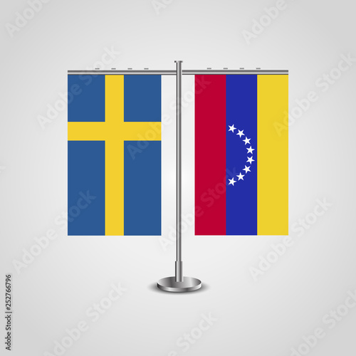 Table stand with flags of Sweden and Venezuela.Two flag. Flag pole. Symbolizing the cooperation between the two countries. Table flags