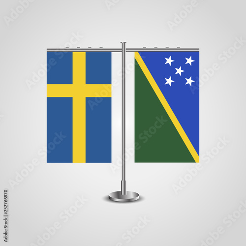 Table stand with flags of Sweden and Solomon islands.Two flag. Flag pole. Symbolizing the cooperation between the two countries. Table flags