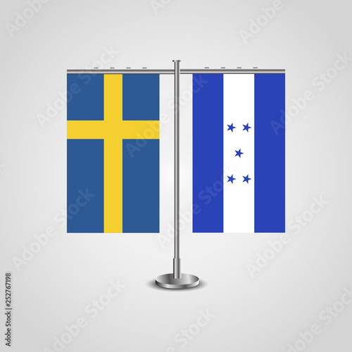 Table stand with flags of Sweden and Honduras.Two flag. Flag pole. Symbolizing the cooperation between the two countries. Table flags