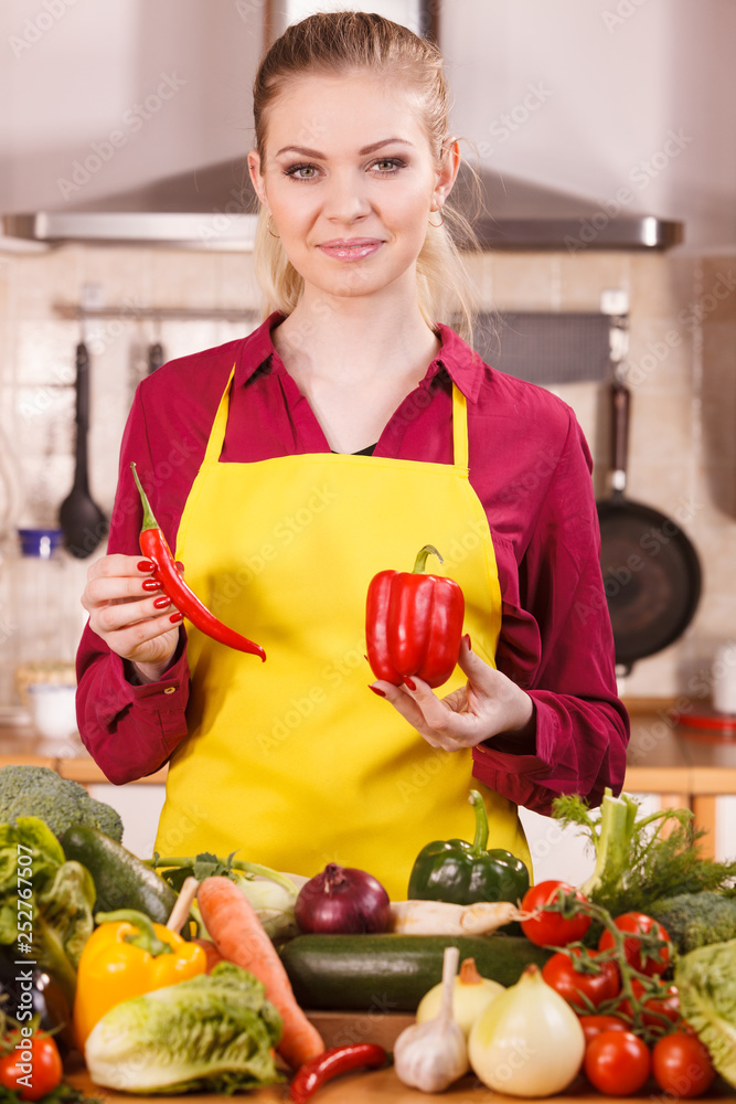Woman holding bell pepper and chilli Woman holding bell pepper and chilli